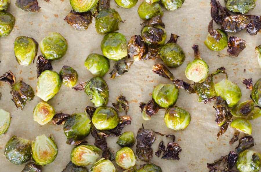overhead view of roasted brussel sprouts on parchment paper