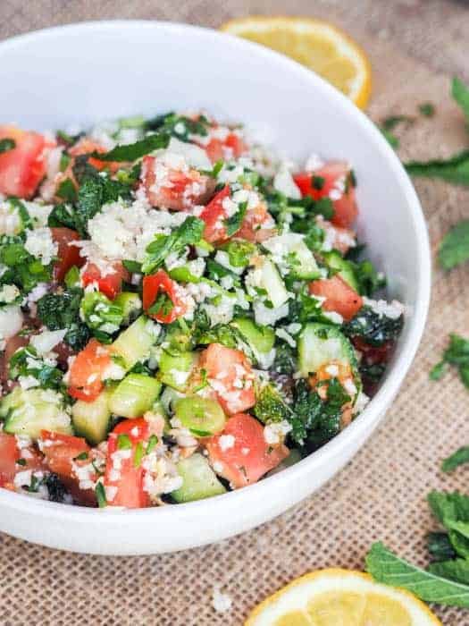 side overhead view of a white bowl full of tabbouleh salad