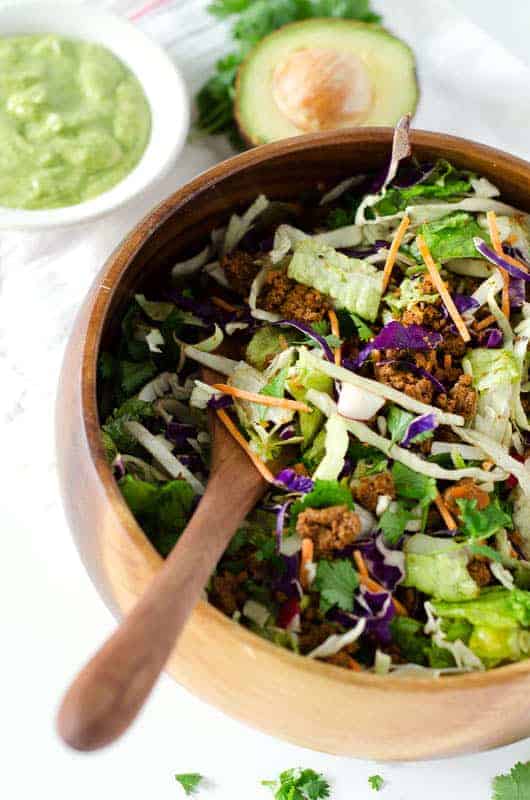 Overhead view of Whole30 taco salad in a wooden salad bowl 