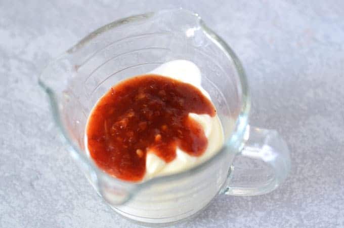 Mayonnaise and chili paste in measuring cup