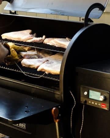 how to use a traeger smoker grill: open traeger grill with meat on it