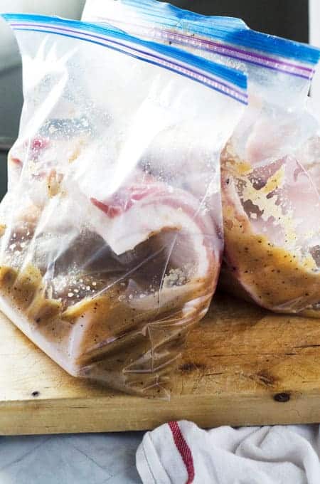 slabs of pork belly in large ziplock bags with curing solution inside