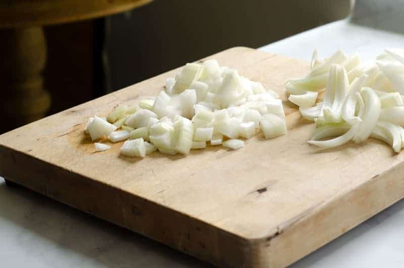 diced and sliced onion pieces on a cutting board