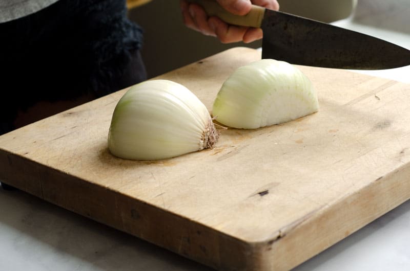 two halves of an onion face down on a cutting board