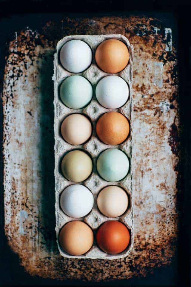 Pastured eggs of varying colors in carton