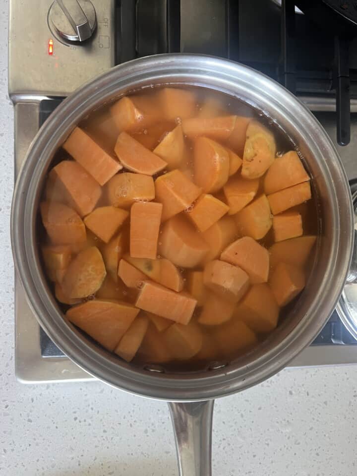 cubed sweet potatoes boiling in water